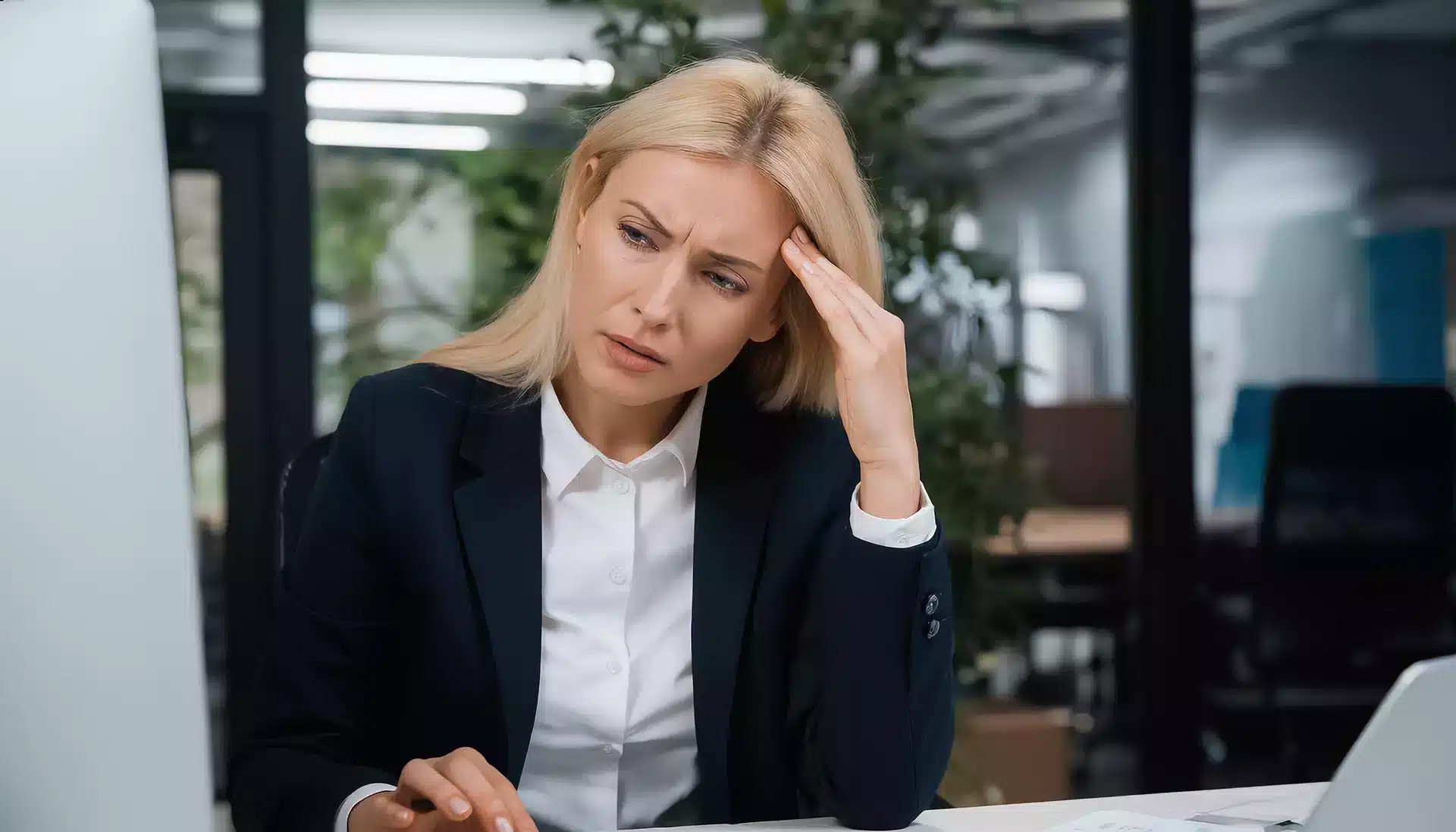 Businesswoman struggling to write website content at her desk